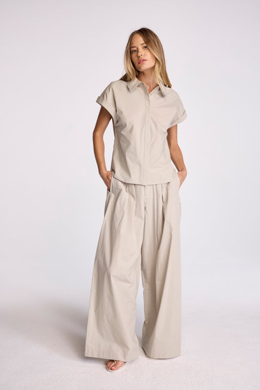 Discover the new Irene Pants, crafted from our signature cotton poplin, these wide-leg pleated pants offer a luxurious yet breathable fit. Designed for the refined and sophisticated, they effortlessly elevate your style. Pair them with the Asher Shirt for the ultimate cool-girl look.