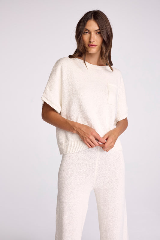 Meet the Liam Sweater. Made from our 100% cotton boucle yarn, this boxy popover features a pocket and elevated rib finishes at the neck, sleeve, and bottom opening. 