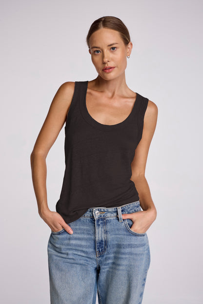 Introducing the Linen Danny Tank - the Danny tank you know and love now in luxurious linen. Experience the elevated fit and casual look of the plunging u-neck. Perfect for layering or wearing alone, this tank exudes effortless elegance and versatility.